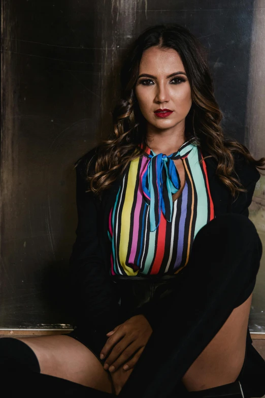 a beautiful young woman sitting on a window sill, a portrait, pexels contest winner, wearing a colorful coogi sweater, bright on black, business attire, camilla luddington
