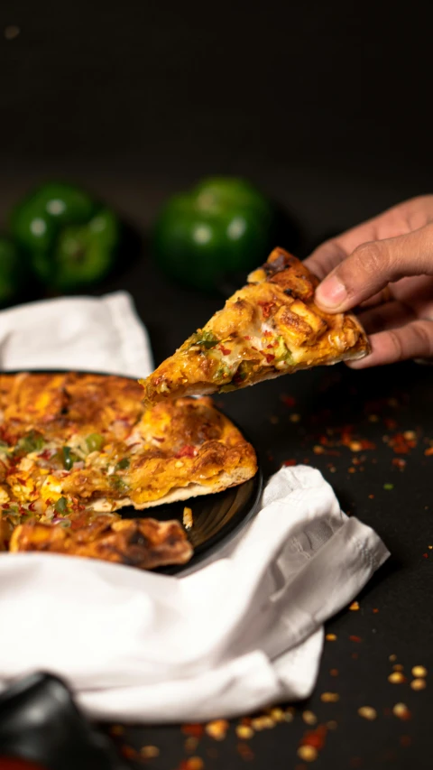 a person taking a slice of pizza out of a pan, inspired by Michelangelo, pexels, hurufiyya, indian, black, spicy, with a soft