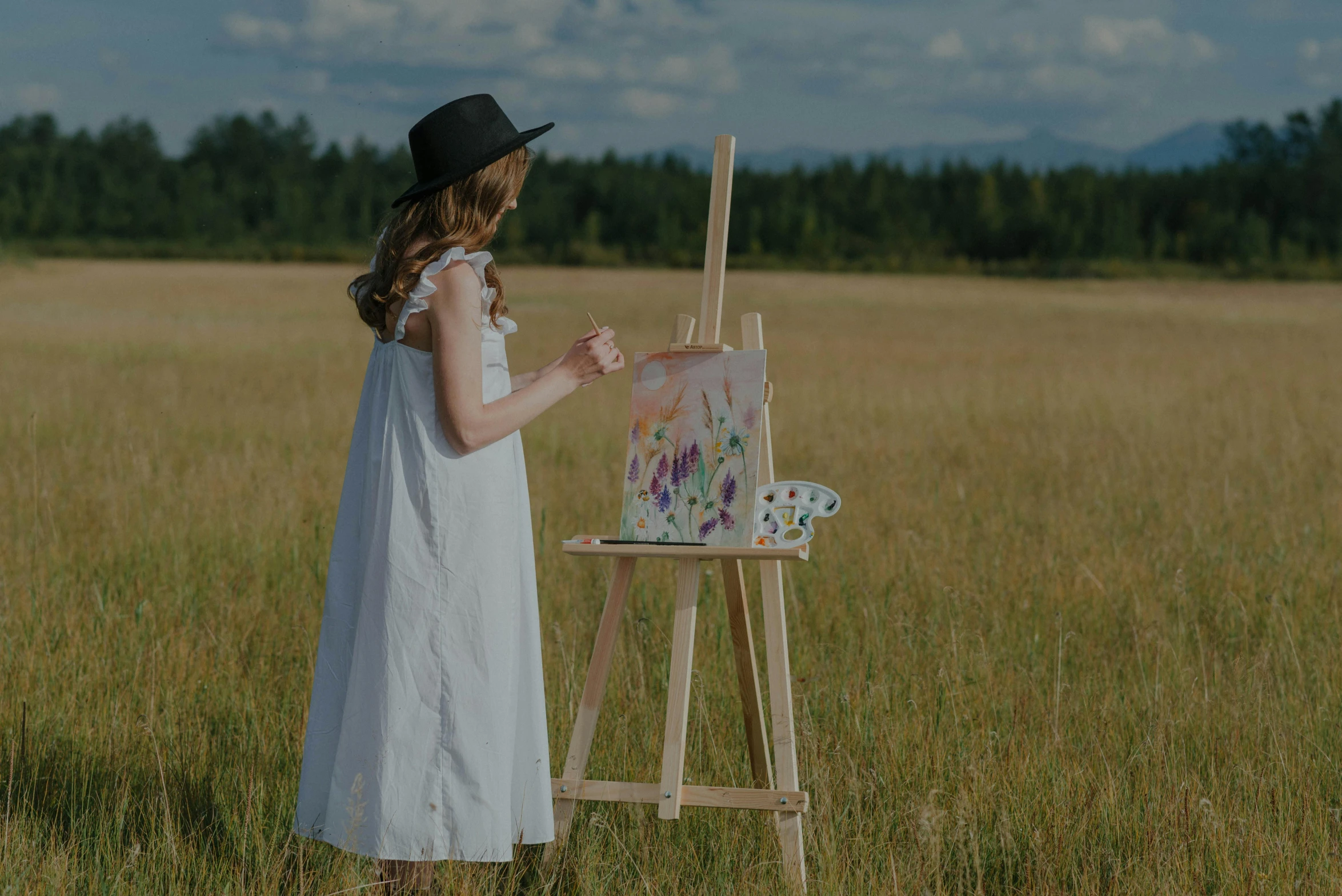 a little girl painting on an easel in a field, inspired by artist, pexels contest winner, wearing a white folkdrakt dress, minimalistic painting, wearing a straw hat and overalls, female art