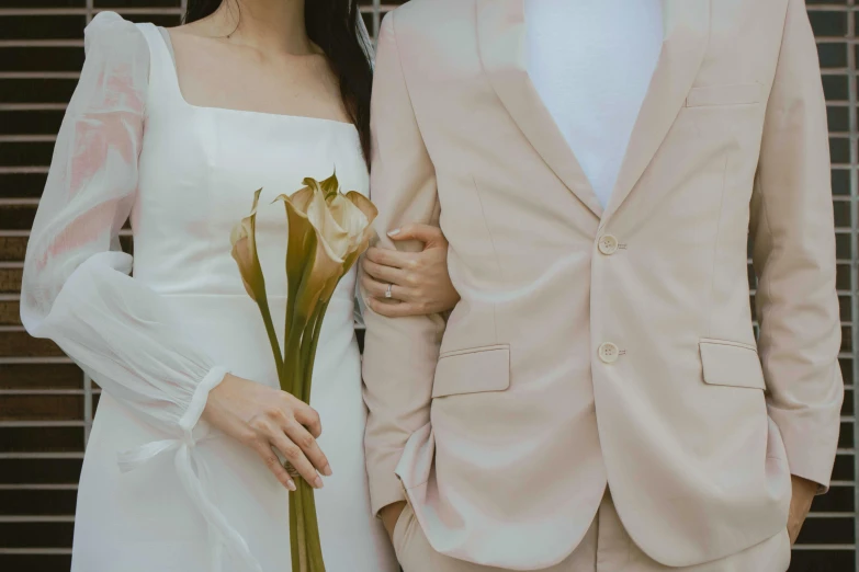 a man and a woman standing next to each other, trending on unsplash, wearing a light - pink suit, holding flowers, wearing white cloths, background image