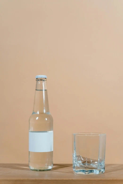 a bottle of water and a glass on a table, by Harvey Quaytman, unsplash, minimalism, ffffound, albino, beer, - 12p