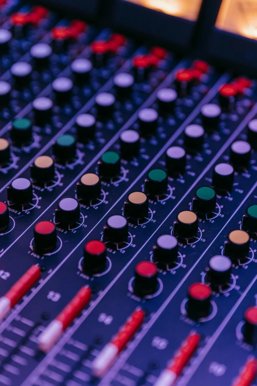 a close up of a mixing board in a recording studio, an album cover, pexels, purple and red, black and blue and purple scheme, schools, radio signals