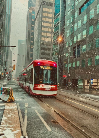 a train traveling in the city during a snow storm