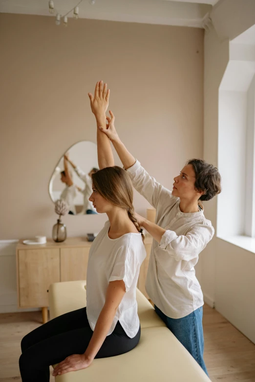 a woman sitting on top of a bench next to a man, by Adam Marczyński, trending on pexels, renaissance, greeting hand on head, acupuncture treatment, stretching to walls, white