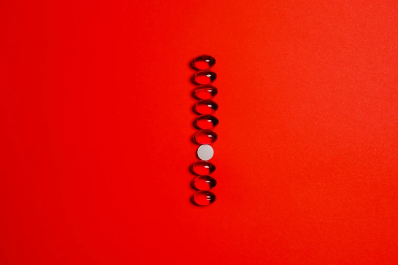 a close up of an object on a red surface, trending on pexels, minimalism, springs, aaaaaaaaaaaaaaaaaaaaaa, ilustration, contracept