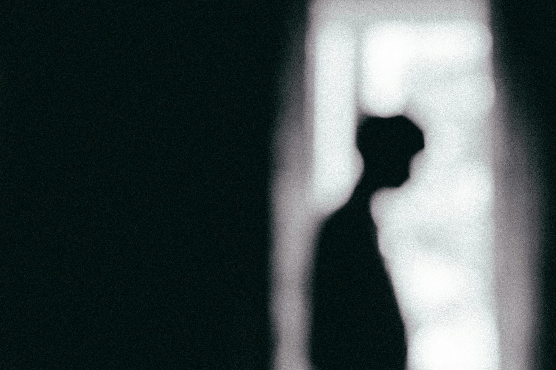 a silhouette of a man standing in front of a window, a black and white photo, pexels contest winner, bauhaus, defocus, hammershoi, instagram post, shadowy creatures