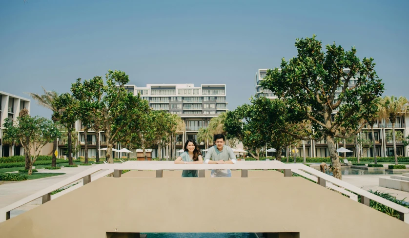 a man and woman standing next to each other on a bridge, inspired by Tadao Ando, beachfront mansion, hua cheng, exterior shot, icon