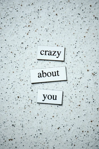 a couple of pieces of paper that say crazy about you, by Caro Niederer, unsplash, magnetic, 15081959 21121991 01012000 4k, frank moth, journalism photo