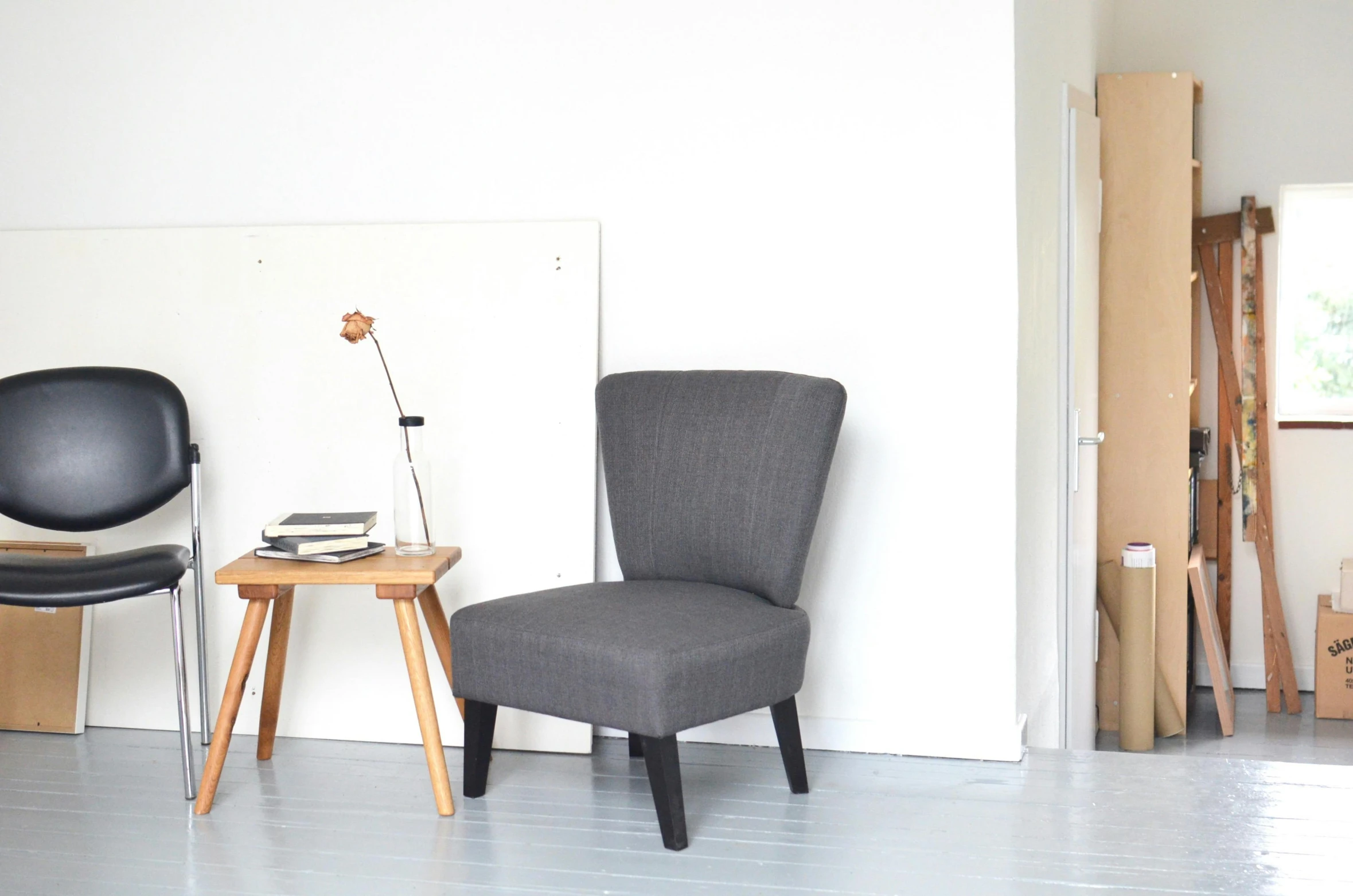 a chair and a table in a room, inspired by Constantin Hansen, dark grey, linus sebastian, small, lined in cotton