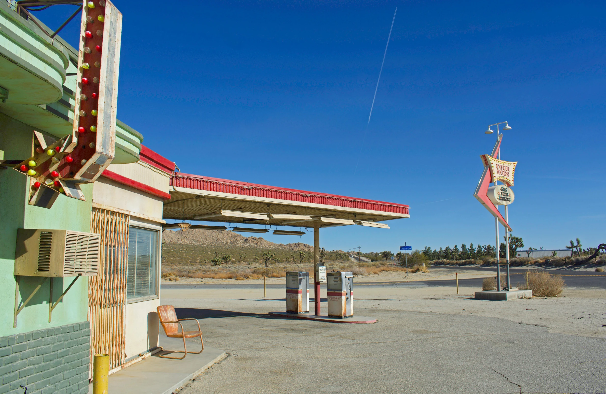 a gas station sitting on the side of a road, by William Berra, flat wastelands, square, blue sky, woo kim