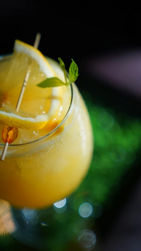 a close up of a drink in a glass on a table, by Matt Cavotta, pexels, renaissance, yellow aureole, mint, thumbnail, slush