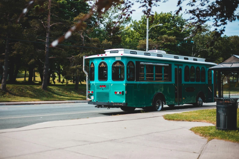 a green bus parked on the side of the road, by Julia Pishtar, unsplash, art nouveau, square, rhode island, cart, teal paper