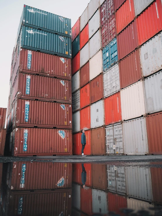 a man standing in front of a stack of shipping containers, pexels contest winner, video footage, ignant, very complex, 90s photo