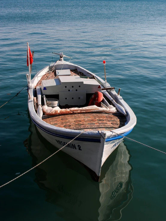 a small boat tied to a rope in the water, cinq terre, slightly smiling, ready to model, pristine and clean
