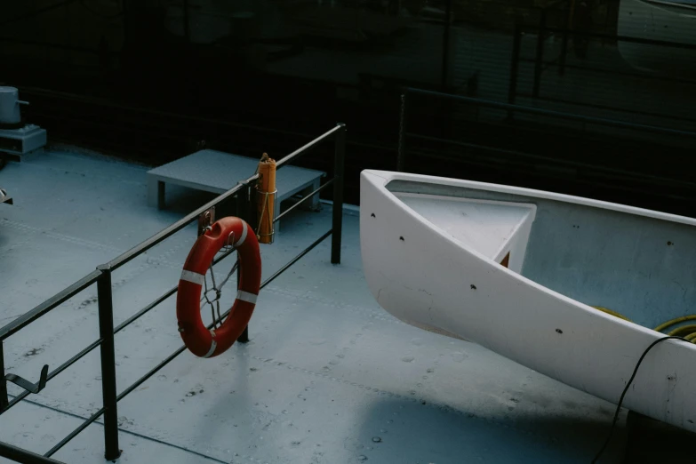 a white boat sitting on top of a boat dock, by Elsa Bleda, pexels contest winner, crimson themed, on a gray background, moody : : wes anderson, injured