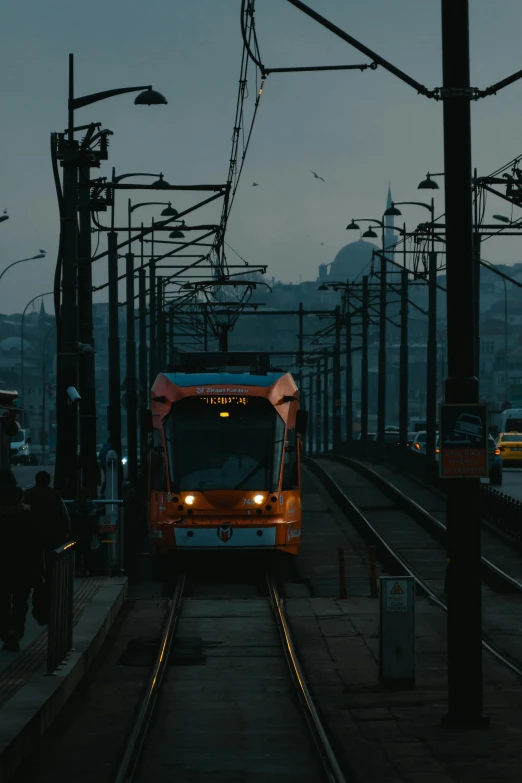 a train traveling down tracks near traffic lights