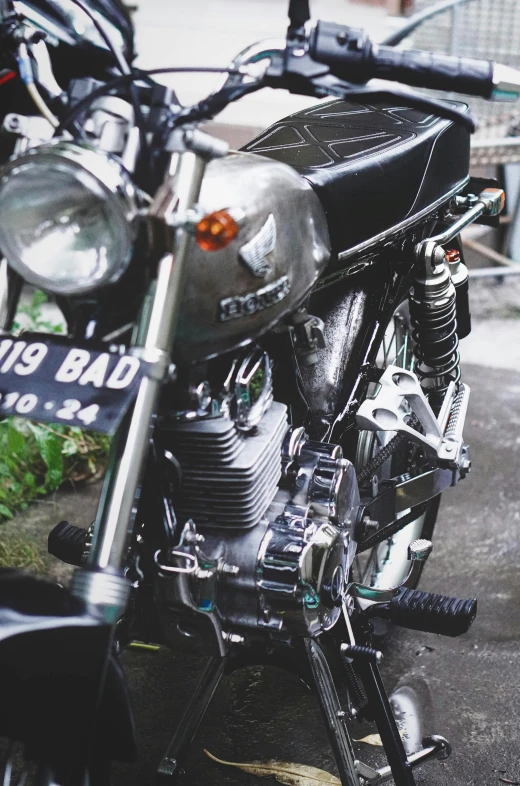 a motorcycle parked on the side of the road, by Daren Bader, unsplash, photorealism, bali, close up details, 🚿🗝📝