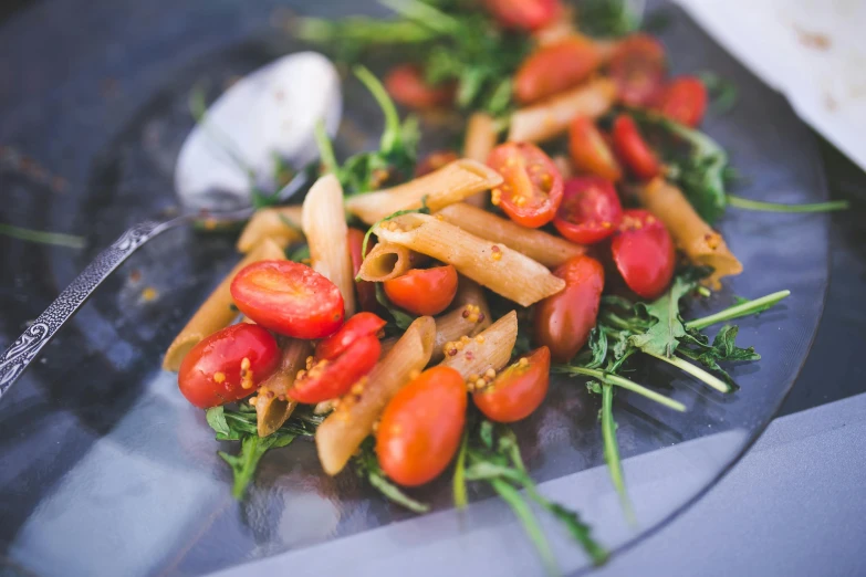 a close up of a plate of food on a table, pexels, tomatoes, pasta, eating outside, greens)