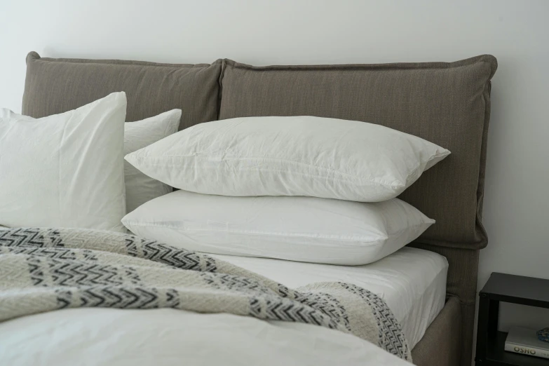 a couple of pillows sitting on top of a bed, zinc white, side angle, sleepers, 3 - piece