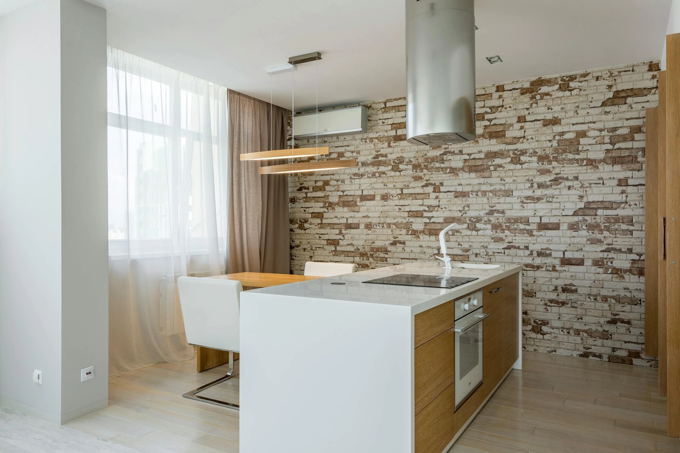 a modern kitchen in the middle of a living room