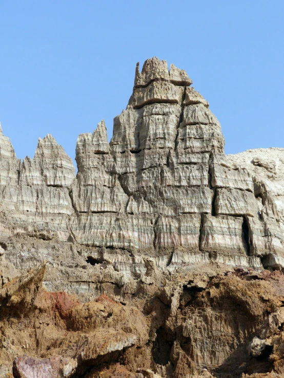 a rock formation near a desert area on a sunny day