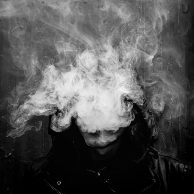 an image of a man with white smoke coming out of his mouth