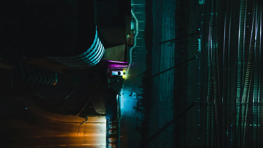 a person walking down a street at night, cyberpunk art, inspired by Elsa Bleda, unsplash contest winner, looking down from above, cyberpunk architecture, teal electricity, nightclub