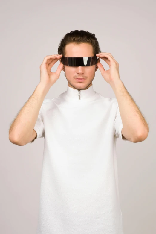 a man holding a pair of glasses over his eyes, a hologram, inspired by Adam Pijnacker, futurism, in white turtleneck shirt, he wears dark visors, modeling, no - text no - logo