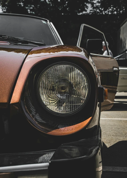 a couple of cars parked next to each other, by Adam Marczyński, pexels contest winner, photorealism, custom headlights, brown, profile image, head macro