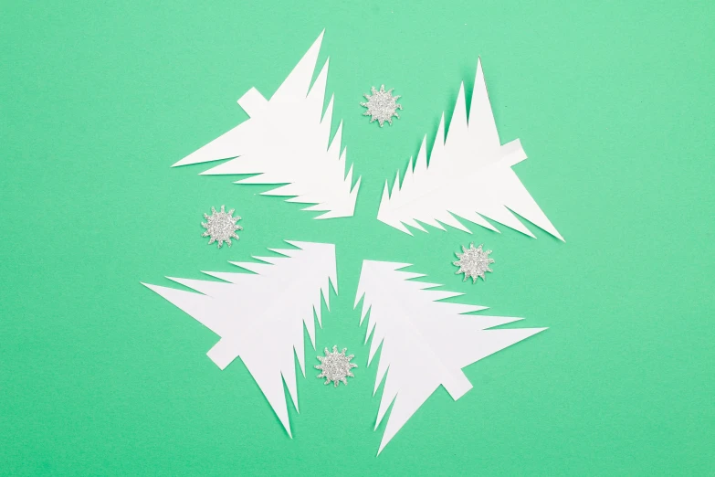 four white paper christmas trees on a green background, by Julia Pishtar, ((trees)), blades, eight eight eight, cast