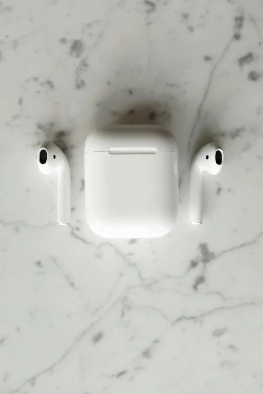 an apple airpods sitting on top of a marble counter, trending on pexels, with pipes attached to it, - 9, perfectly symmetrical, square