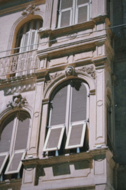 a tall building with many windows and balconies, inspired by Carlo Galli Bibiena, art nouveau, photo 1998, architectural finishes, awnings, detail shot