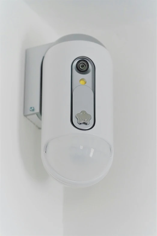 a close up of a light on a wall, diaper disposal robot, front facing camera, full body profile camera shot, security camera