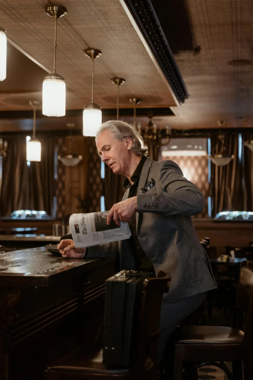 a man that is standing at a bar, by Jan Tengnagel, happening, reading a newspaper, henrik fisker, gray haired, thumbnail