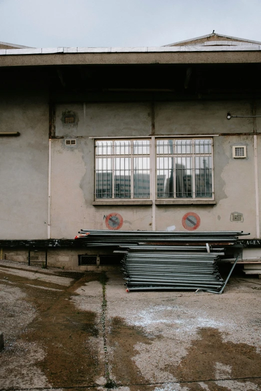 there is no image here to provide a caption for, a picture, by Tobias Stimmer, unsplash, graffiti, construction yard, rainy; 90's photograph, barracks, metal bars