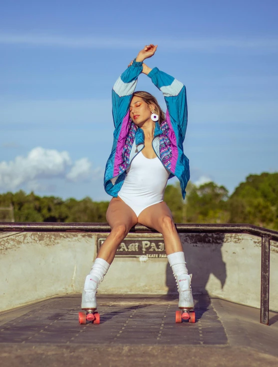 a woman standing on top of a skateboard ramp, an album cover, by Julia Pishtar, unsplash, happening, skimpy shorts, white and teal garment, cardi b, performing a music video