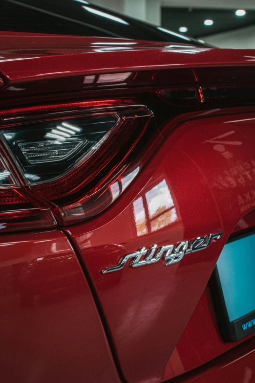 closeup of the tail light and emblem on a red car