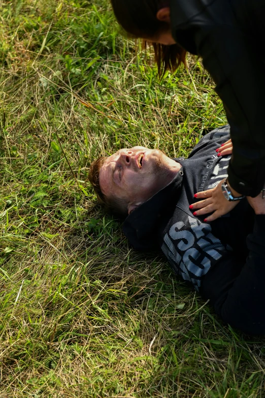 a person laying on the ground with their face in their hands