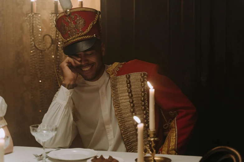 a man dressed in a king costume sitting at a table