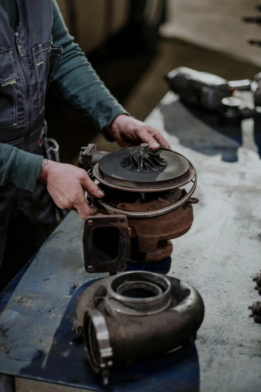 a man working on a machine in a factory, by Glennray Tutor, pexels contest winner, arbeitsrat für kunst, cast iron material, turbo, made of polished broze, instagram story