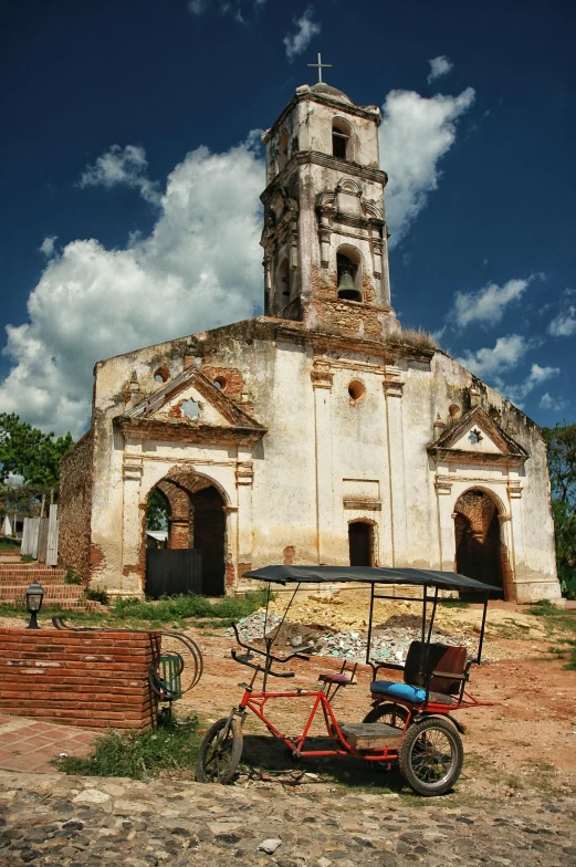 an old bike parked outside of an historic church