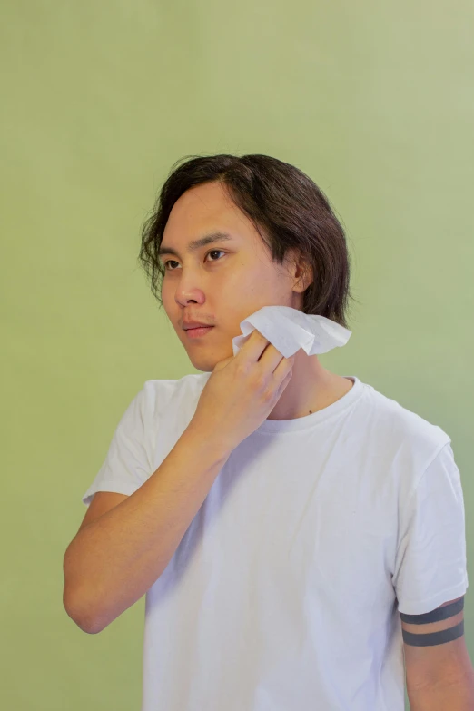 a man standing in front of a mirror brushing his teeth, an album cover, inspired by Fei Danxu, chiseled jawline, wearing translucent sheet, wikihow, full product shot