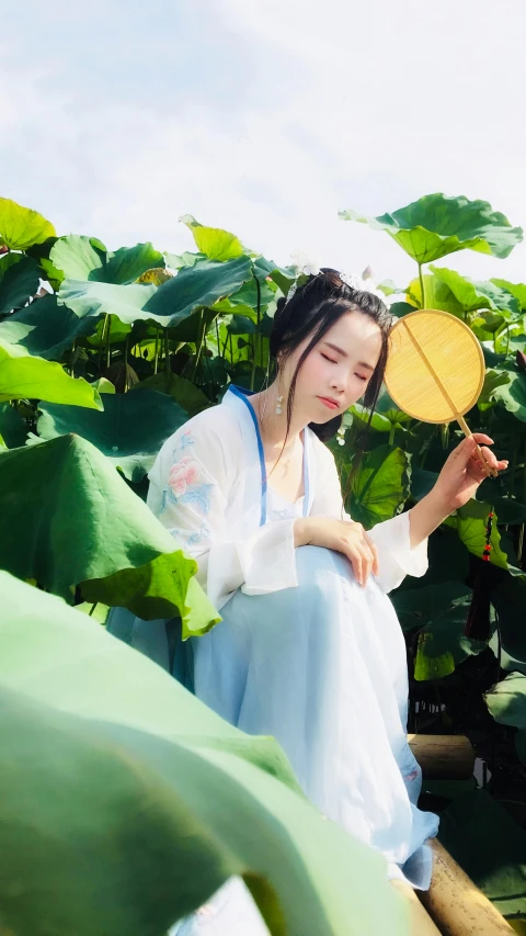 a woman sitting on a boat holding a fan, an album cover, inspired by Tang Yifen, pexels contest winner, in a garden, cotton, iu, 15081959 21121991 01012000 4k