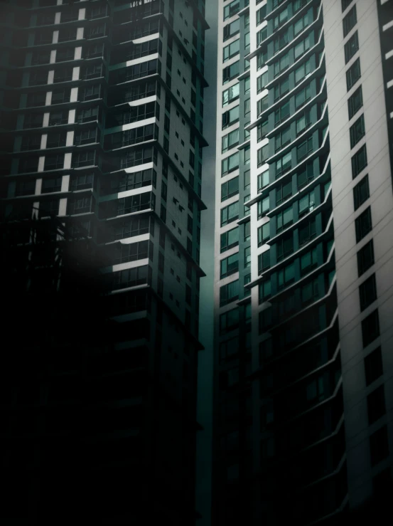 a tall building sitting in the middle of a city, inspired by Cheng Jiasui, pexels contest winner, modernism, dark shadowy surroundings, abstract facades of buildings, three towers, window ( city )