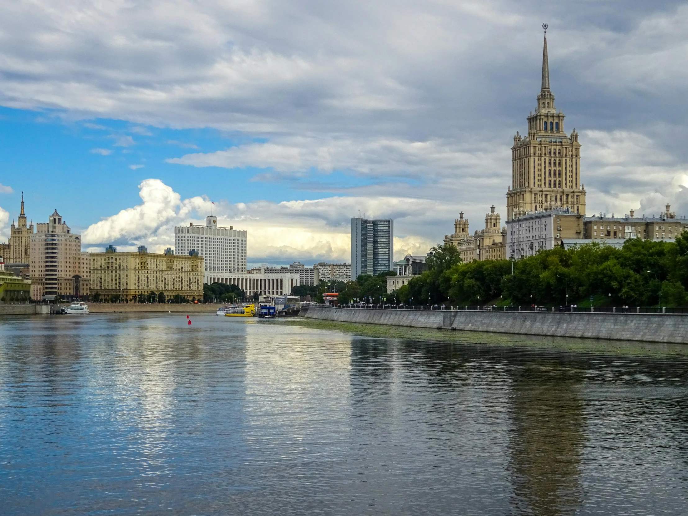 a body of water in front of a tall building