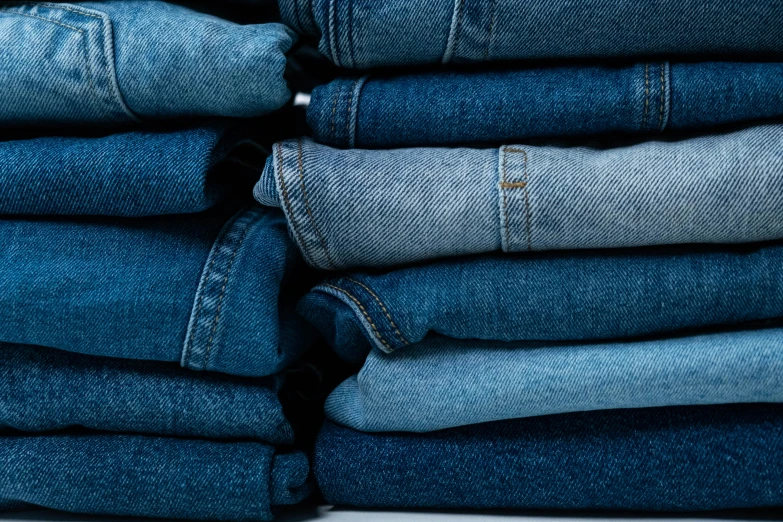 a stack of blue jeans stacked on top of each other, trending on unsplash, renaissance, scrubs, made of fabric, various sizes, dezeen