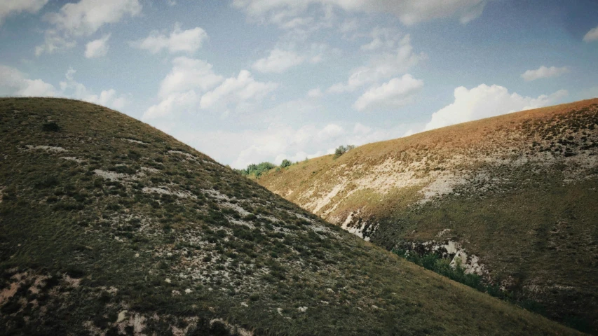 the two hills are covered in small vegetation