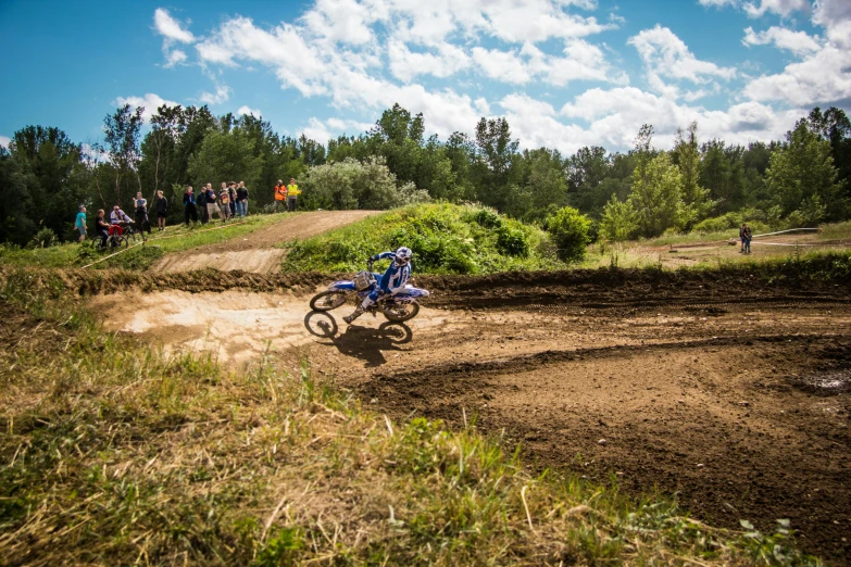 a man riding a dirt bike on a dirt track