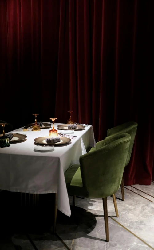 a dinner table in a restaurant setting with plates and silverware