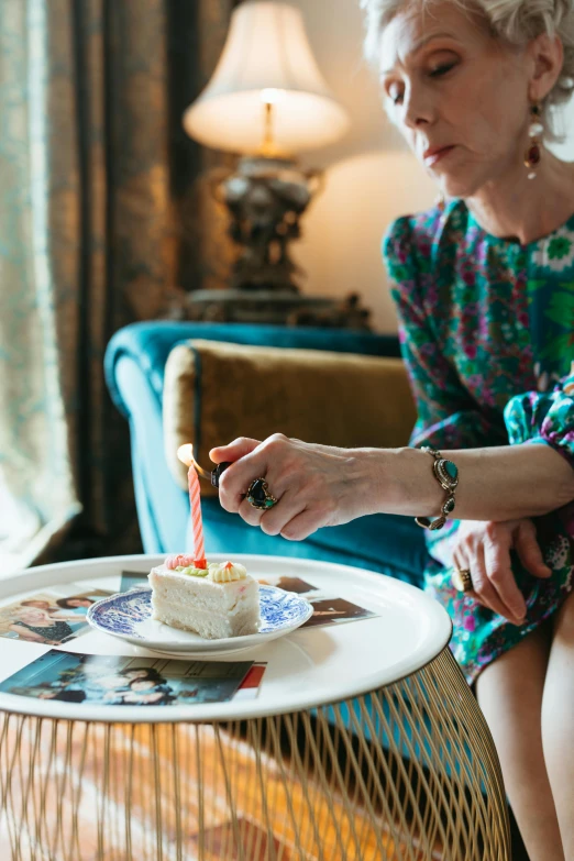 a woman sitting on a couch blowing out a candle, birthday cake, marie - gabrielle capet style, dan mumfor, profile image